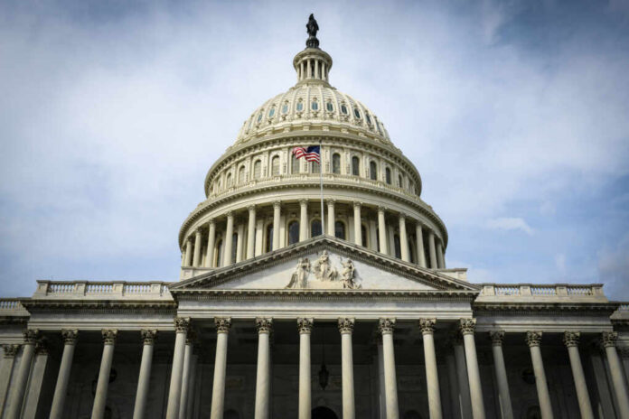 shutterstock_179079596 The U.S. Capitol building with an American flag flying in front