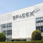 Wall Street Bet Mints First Trillionaire Exterior view of the SpaceX building with a prominent logo