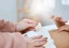 Caregiver changing a baby's diaper
