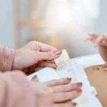 Caregiver changing a baby's diaper