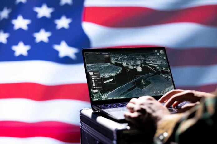 Laptop with surveillance software against a blurred American flag