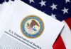 Official U.S. Department of Justice document on an American flag background
