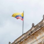 Colombian flag atop a neoclassical building