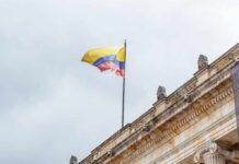 Colombian flag atop a neoclassical building