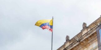 Colombian flag atop a neoclassical building