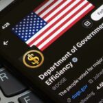 Social Security Nightmare Brewing Inside DOGE Close-up of a smartphone displaying a Twitter profile with an American flag