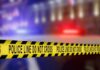 Body Near Stadium Sparks Wild Suspicions Yellow police tape reading 'DO NOT CROSS' at a crime scene
