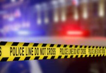 Body Near Stadium Sparks Wild Suspicions Yellow police tape reading 'DO NOT CROSS' at a crime scene