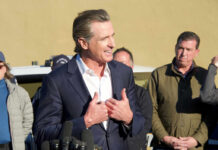 Insider Flips — Capitol Panic Ensues Politician speaking at a press conference with a group of people in the background