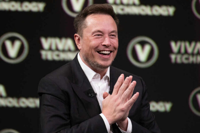Smiling speaker at a technology conference with hands clasped together