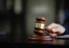 A wooden gavel resting on a desk, symbolizing justice and legal proceedings