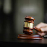 A wooden gavel resting on a desk, symbolizing justice and legal proceedings