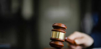 A wooden gavel resting on a desk, symbolizing justice and legal proceedings