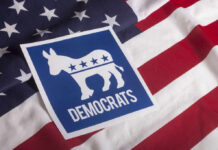 Top Democrats Urge Nominee To Quit Democratic Party logo featuring a donkey on an American flag background