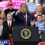Trade Victory Claim Sparks Michigan Uproar politician speaking at a rally podium