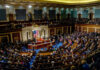Election Debate Returns To Center Stage A large gathering of officials in a congressional chamber during a legislative session