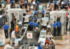 New Ebola Rules Restrict U.S. Travel Busy airport security checkpoint with travelers and TSA agents