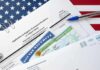immigration forms with green card and social security card on US flag background