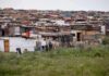Informal settlement of corrugated metal shacks with laundry hanging