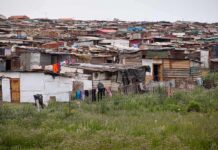 Informal settlement of corrugated metal shacks with laundry hanging