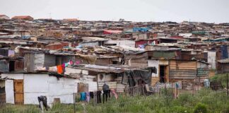 Informal settlement of corrugated metal shacks with laundry hanging