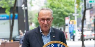 man speaking at a podium with a United States Senate seal