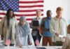 Voters standing in line at a polling station