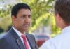 Congressman’s Wealth Draws Fresh Questions Two professionals engaged in a conversation outdoors