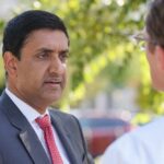 Congressman’s Wealth Draws Fresh Questions Two professionals engaged in a conversation outdoors
