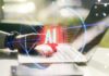 Is AI Making Students Think Less? A hand interacting with a laptop displaying an AI symbol