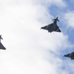 Saudi Airspace Clash Claims Escalate Three fighter jets flying in formation against a cloudy sky