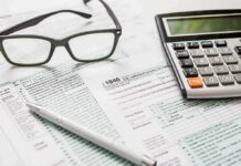 Missouri Voters Reject Income Tax Plan Tax forms with calculator, glasses, and pen