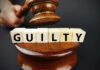 Judge's gavel above blocks spelling guilty