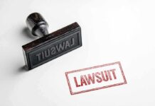 Rubber stamp with red lawsuit imprint on white paper