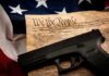DOJ Reopens Path To Restore Gun Rights Handgun on U.S. Constitution with American flag backdrop