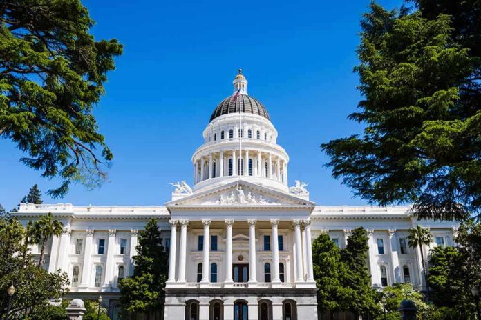 State capitol building with white dome and columns framed by trees