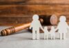 Ohio House Of Horrors Takes Dark Turn Paper cutout family with gavel in background