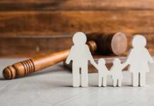 Paper cutout family with gavel in background