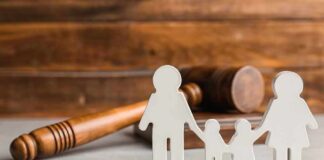 Paper cutout family with gavel in background
