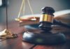 Judge's gavel on block with scales of justice