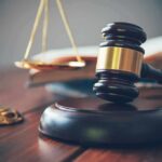 Judge's gavel on block with scales of justice