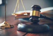 Judge's gavel on block with scales of justice