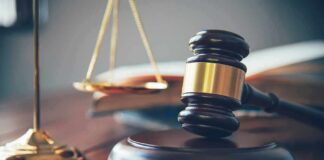 Judge's gavel on block with scales of justice