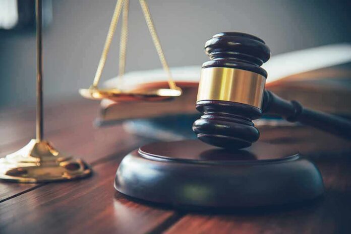 shutterstock_1147399469 Judge's gavel on block with scales of justice