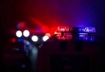 Police car light bar flashing red and blue at night