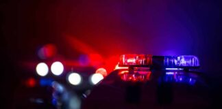 Police car light bar flashing red and blue at night