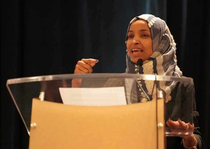 Woman in hijab speaking at a podium