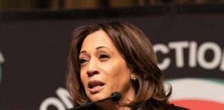 woman speaking at a podium with microphone