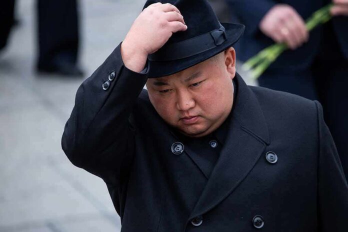 man in black coat adjusting a black hat
