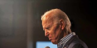 elderly man holding a microphone on stage